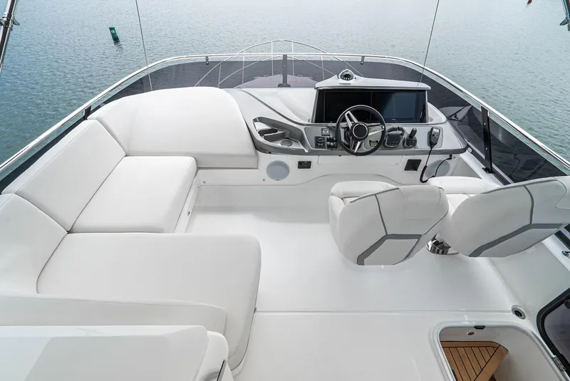 Slide: The Image of 2024 Princess F45 yacht flybridge with modern helm and seating area. - 16