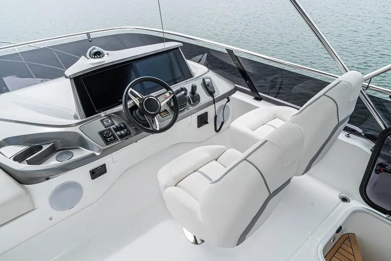 Slide: The Image of 2024 Princess F45 yacht helm station with modern controls and luxurious seating. - 17