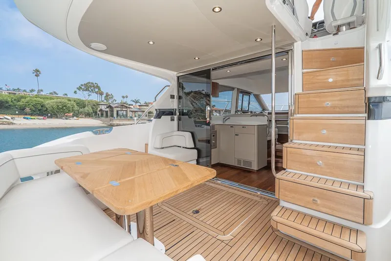 Slide: The Image of 2024 Princess F45 yacht interior with wooden stairs and seating area. - 22