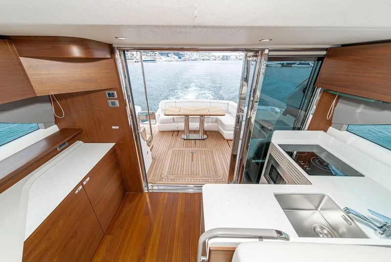 Slide: The Image of Interior of 2024 Princess F45 yacht with modern kitchen and open deck view. - 24
