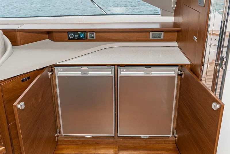 Slide: The Image of 2024 Princess F45 yacht interior kitchen with open cabinets and modern appliances. - 26