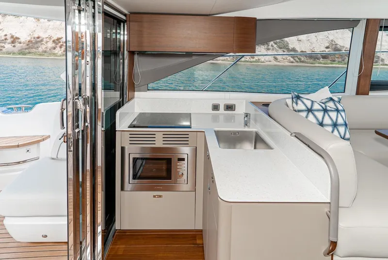 Slide: The Image of Modern kitchen area on the 2024 Princess F45 yacht with sleek design and ocean view. - 27