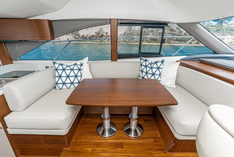 Slide: The Image of Interior seating area of 2024 Princess F45 yacht with wooden table and white cushions. - 31