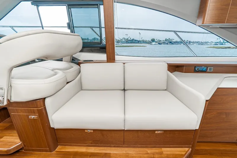 Slide: The Image of 2024 Princess F45 yacht interior with white leather seating and wooden accents. - 33
