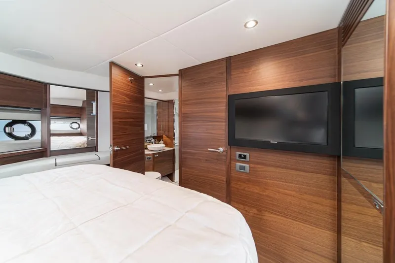 Slide: The Image of 2024 Princess F45 yacht interior bedroom with TV and ensuite bathroom. - 36