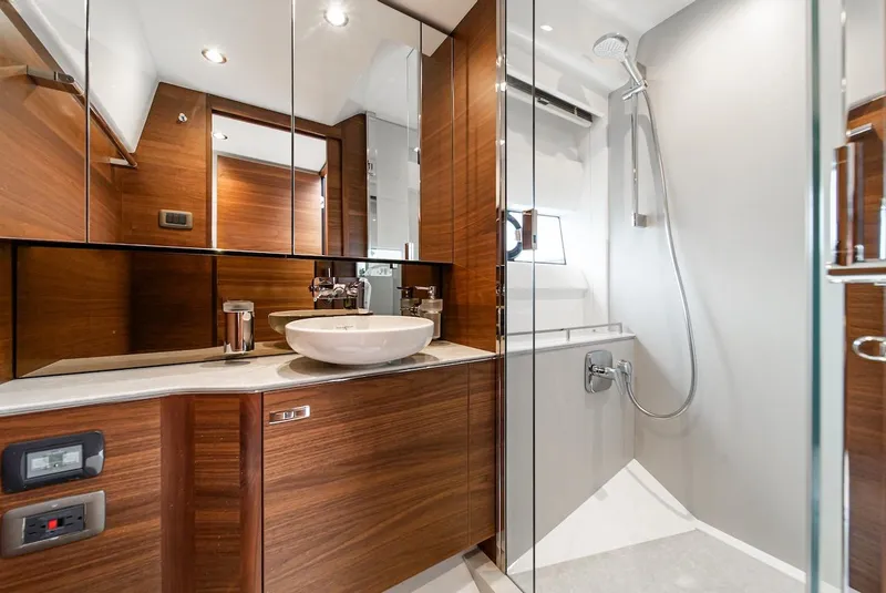 Slide: The Image of Luxurious bathroom in 2024 Princess F45 yacht with modern fixtures and wooden cabinetry. - 42