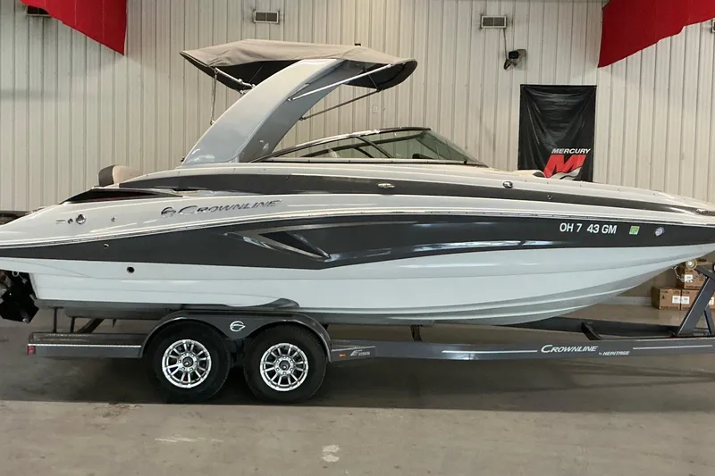 Slide: The Image of 2021 Crownline Eclipse E255 boat on trailer in showroom setting. - 18