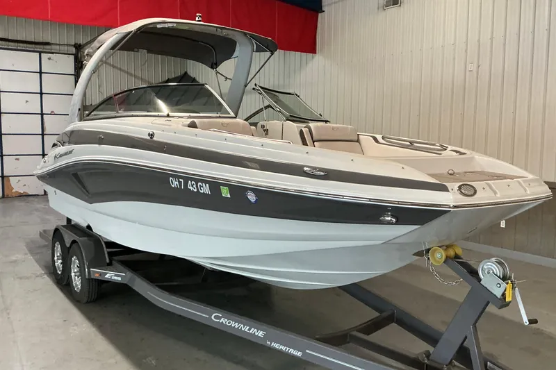 Slide: The Image of 2021 Crownline Eclipse E255 boat on trailer in indoor storage. - 19