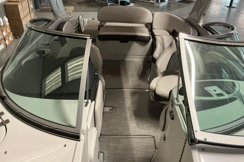 Slide: The Image of 2021 Crownline Eclipse E255 boat interior with seating and windshield in a showroom. - 28