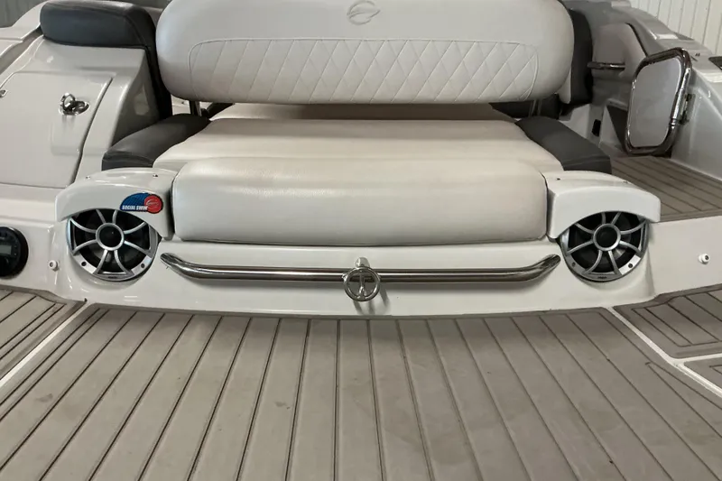 Slide: The Image of 2021 Crownline Eclipse E255 boat interior with cushioned seating and integrated speakers. - 34