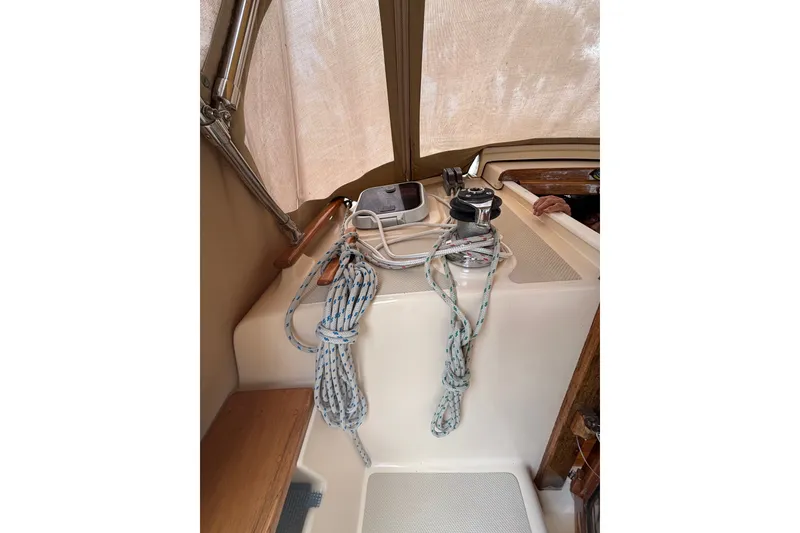 Slide: The Image of 1994 Island Packet 32 sailboat cockpit with ropes and winch. - 30