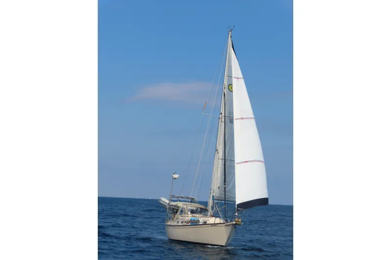 Slide: The Image of Sailing yacht Island Packet 32, 1994 model, cruising on open sea under clear blue sky. - 2