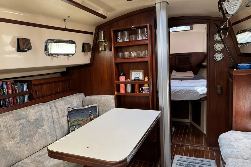Slide: The Image of Cozy interior of a 1994 Island Packet 32 sailboat with dining area and cabin. - 20