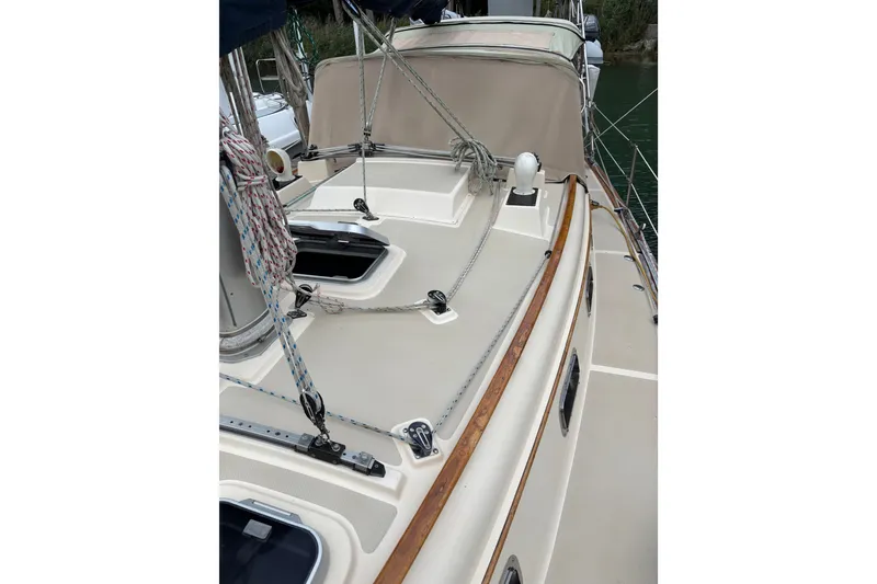 Slide: The Image of 1994 Island Packet 32 sailboat deck with rigging and wood trim. - 17