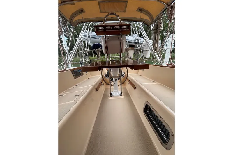 Slide: The Image of Cockpit of 1994 Island Packet 32 sailboat with steering wheel and seating. - 28