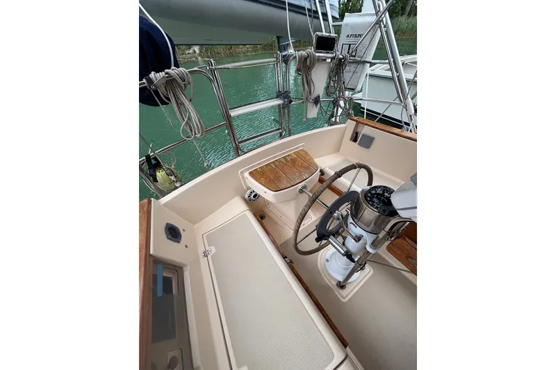 Slide: The Image of Cockpit of 1994 Island Packet 32 sailboat with steering wheel and navigation instruments. - 22