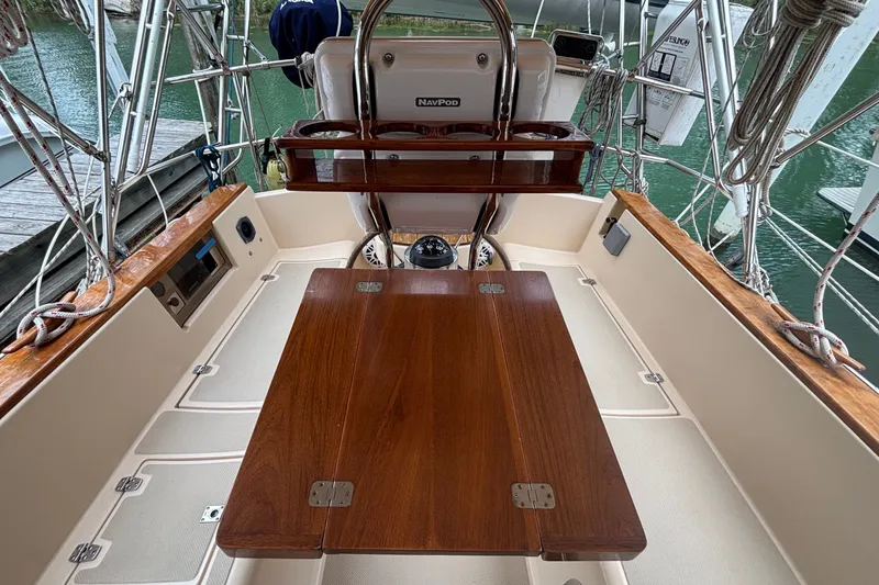 Slide: The Image of Cockpit of 1994 Island Packet 32 sailboat with wooden table and steering wheel. - 29