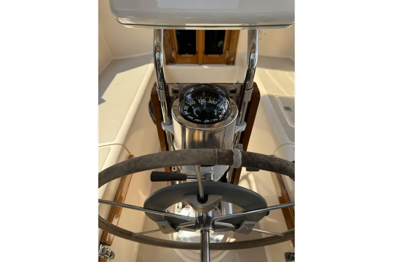 Slide: The Image of Steering wheel and compass of a 1994 Island Packet 32 sailboat cockpit. - 8