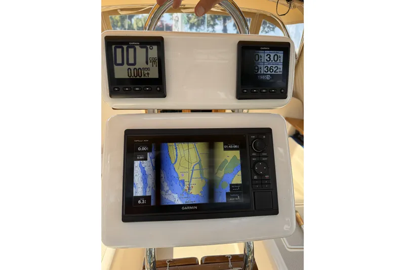 Slide: The Image of Garmin navigation system on 1994 Island Packet 32 sailboat, displaying maps and speed data. - 9