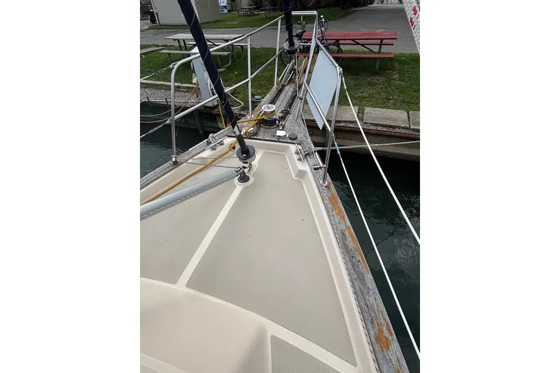 Slide: The Image of Bow view of 1994 Island Packet 32 sailboat docked near a canal. - 14