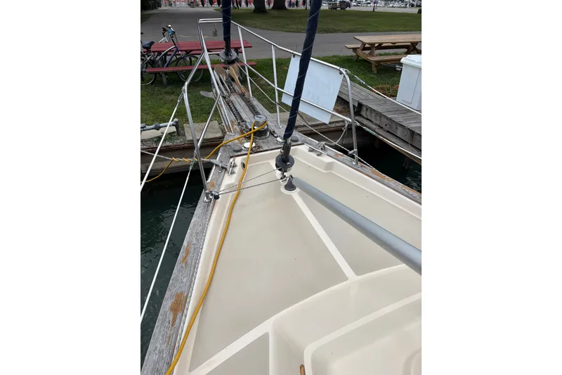 Slide: The Image of Bow of 1994 Island Packet 32 sailboat docked, showing deck and railing. - 13