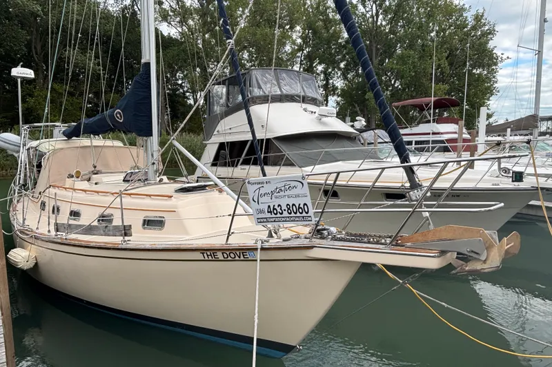 Slide: The Image of 1994 Island Packet 32 sailboat, "The Dove," docked at marina with other boats. - 10