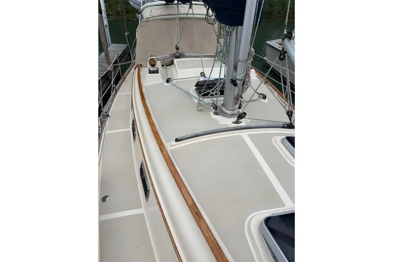 Slide: The Image of 1994 Island Packet 32 sailboat deck with rigging and wooden trim. - 16