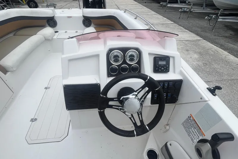 Slide: The Image of 2021 Starcraft SVX 211 OB boat dashboard with steering wheel and control panel. - 16