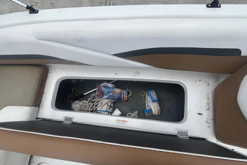 Slide: The Image of Open storage compartment on 2021 Starcraft SVX 211 OB boat with ropes and miscellaneous items. - 19