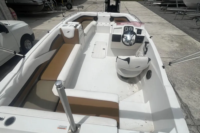 Slide: The Image of 2021 Starcraft SVX 211 OB boat interior with seating and steering console. - 21