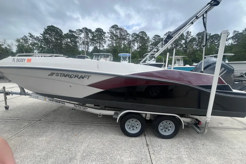 Slide: The Image of 2021 Starcraft SVX 211 OB boat on trailer, parked outdoors. - 4