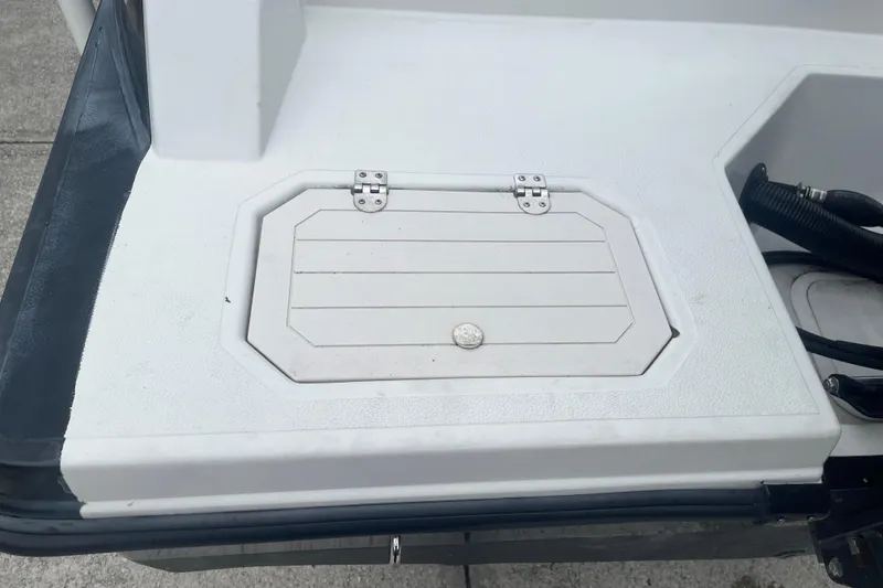 Slide: The Image of 2021 Starcraft SVX 211 OB boat hatch detail with textured surface and hinges. - 8