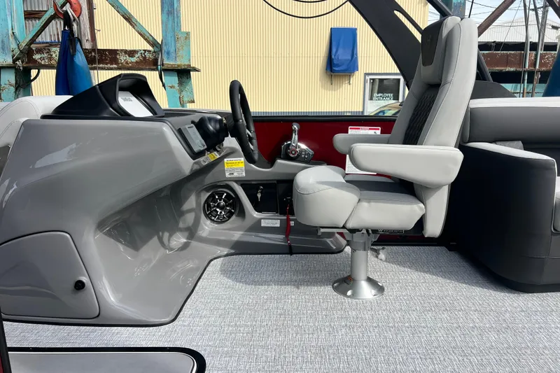 Slide: The Image of 2026 Harris Sunliner 230 boat interior with captain's chair and control panel. - 12