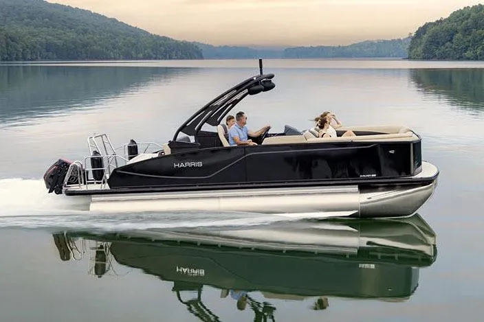 Slide: The Image of Manufacturer Provided Image: 2026 Harris Sunliner 230 pontoon boat cruising on a serene lake. - 3