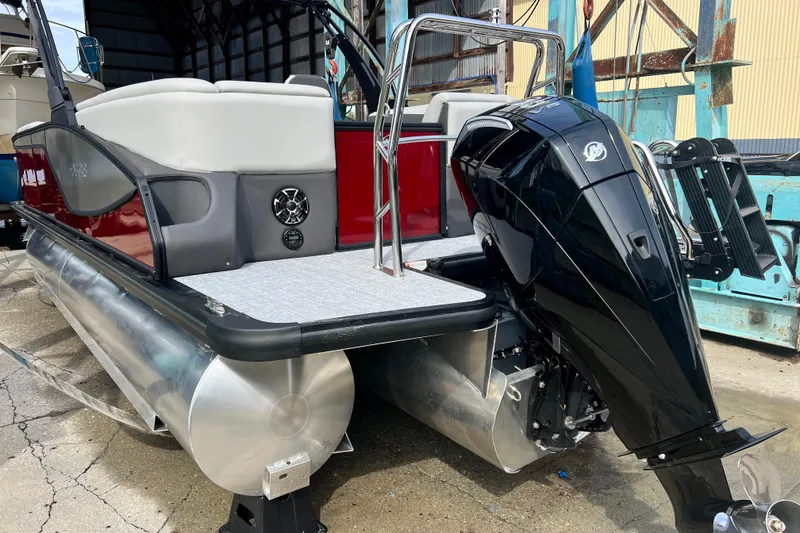 Slide: The Image of 2026 Harris Sunliner 230 pontoon boat with sleek design and powerful outboard motor. - 7