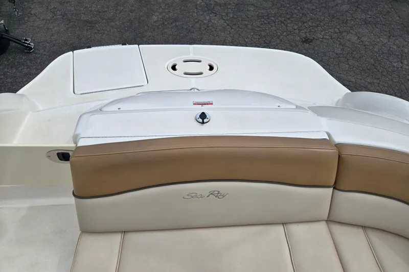 Slide: The Image of 2011 Sea Ray 200 Sundeck boat interior with tan and white seating. - 11