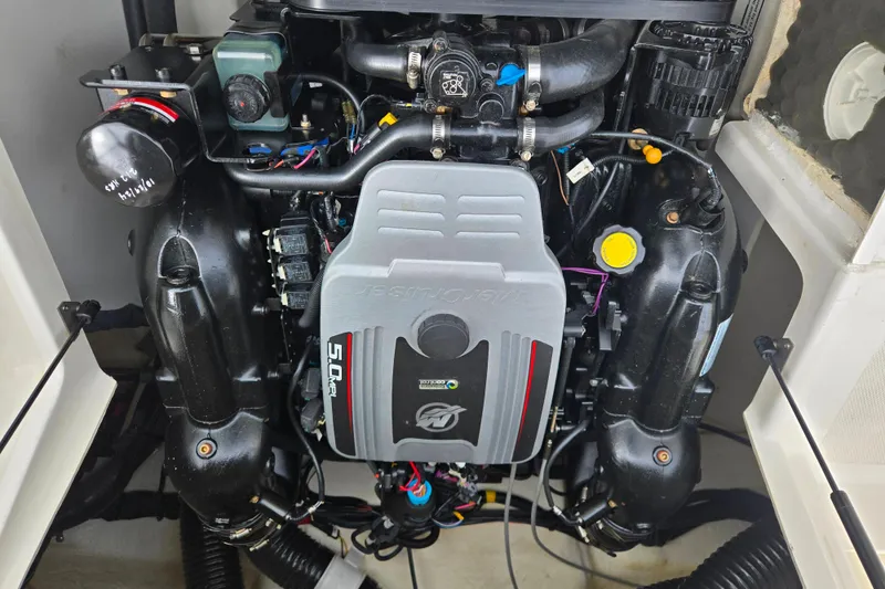 Slide: The Image of Engine of a 2011 Sea Ray 200 Sundeck boat, showcasing detailed components. - 12