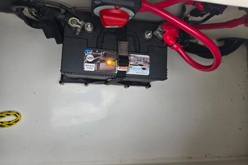 Slide: The Image of Battery compartment of a 2011 Sea Ray 200 Sundeck with visible wiring and connections. - 13