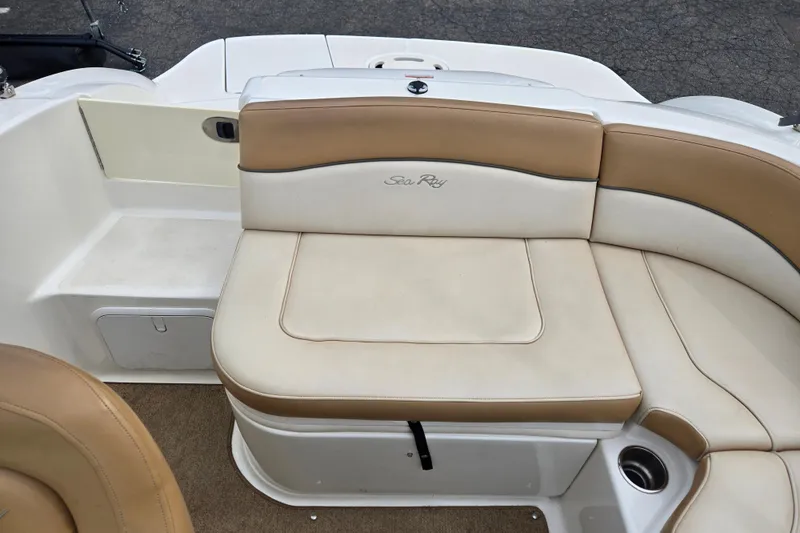 Slide: The Image of 2011 Sea Ray 200 Sundeck boat seating with tan and cream upholstery. - 14