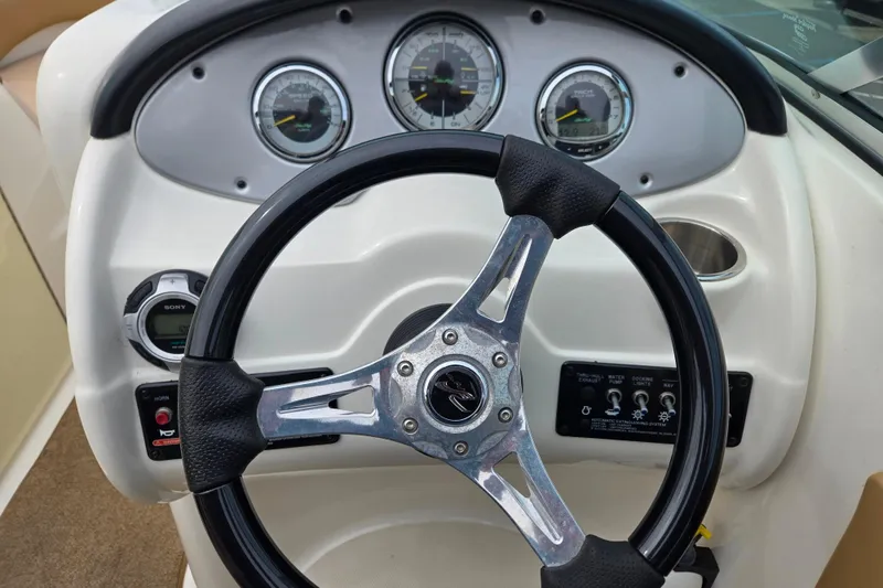 Slide: The Image of Steering wheel and dashboard of 2011 Sea Ray 200 Sundeck boat. - 18