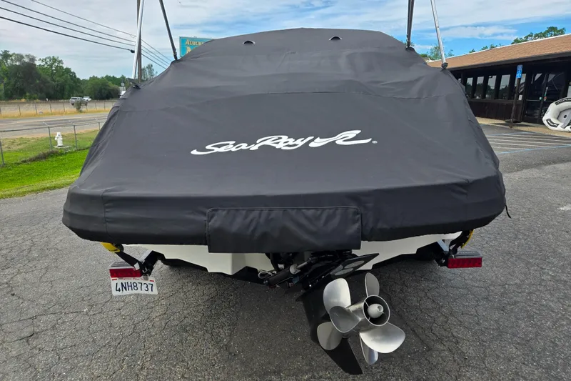 Slide: The Image of 2011 Sea Ray 200 Sundeck boat with cover, rear view showing propeller. - 21