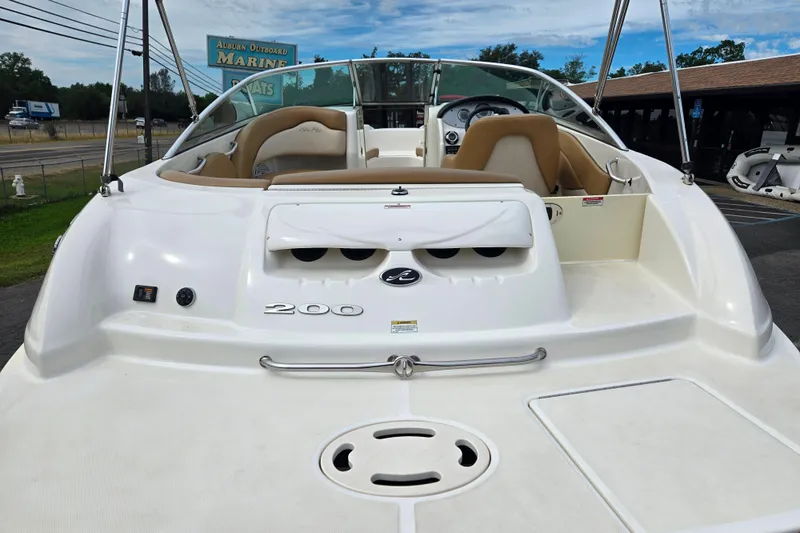 Slide: The Image of 2011 Sea Ray 200 Sundeck boat with tan seating, displayed outdoors. - 4