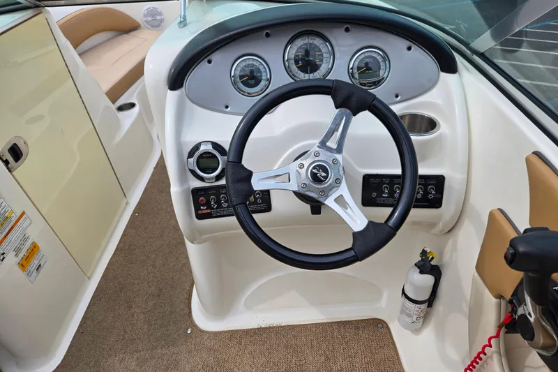 Slide: The Image of Steering console of a 2011 Sea Ray 200 Sundeck boat with gauges and controls. - 7