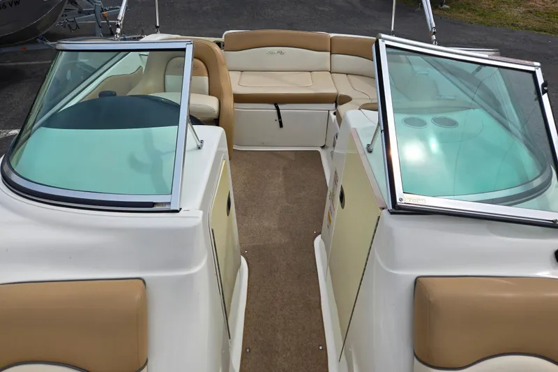 Slide: The Image of 2011 Sea Ray 200 Sundeck interior with tan seating and open windshield. - 8