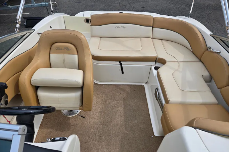 Slide: The Image of Interior of 2011 Sea Ray 200 Sundeck boat with beige and white seating. - 9
