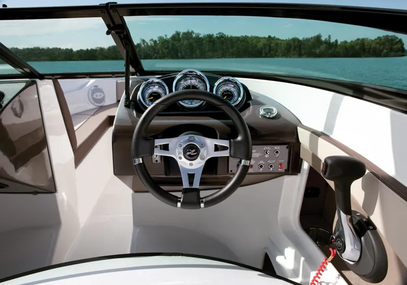 Slide: The Image of Manufacturer Provided Image: 2013 Sea Ray 190 Sport boat dashboard with steering wheel and control panel. - 14