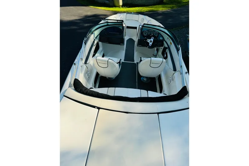Slide: The Image of 2013 Sea Ray 190 Sport boat interior with white seating and dashboard view. - 3