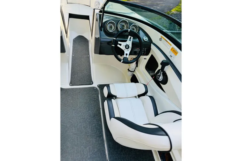 Slide: The Image of Interior of 2013 Sea Ray 190 Sport boat with steering wheel and seating. - 4