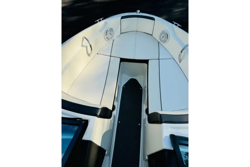 Slide: The Image of 2013 Sea Ray 190 Sport boat interior with white seating and black accents. - 6