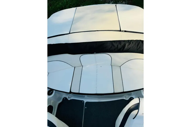Slide: The Image of 2013 Sea Ray 190 Sport boat interior with white cushioned seating. - 7